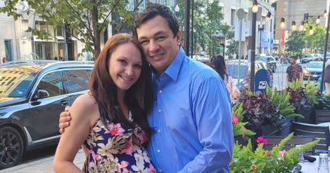 A very pregnant Ashley Sherwood smiles and poses with Shane in front of a restaurant.