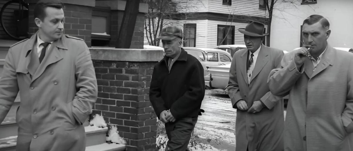 Ed Gein walks with detectives.