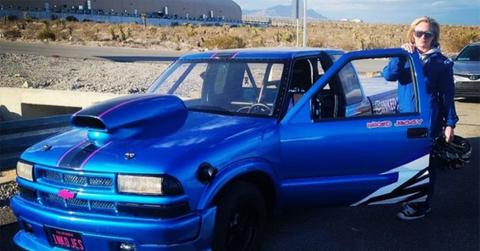 Jessica Heath poses with a blue Chevrolet.