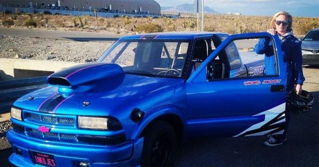 Jessica Heath poses with a blue Chevrolet.