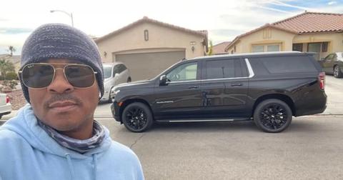 Deon Derrico standing by a black SUV.