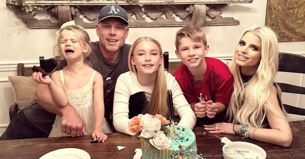 Eric Johnson, Jessica Simpson, and their three kids with a birthday cake