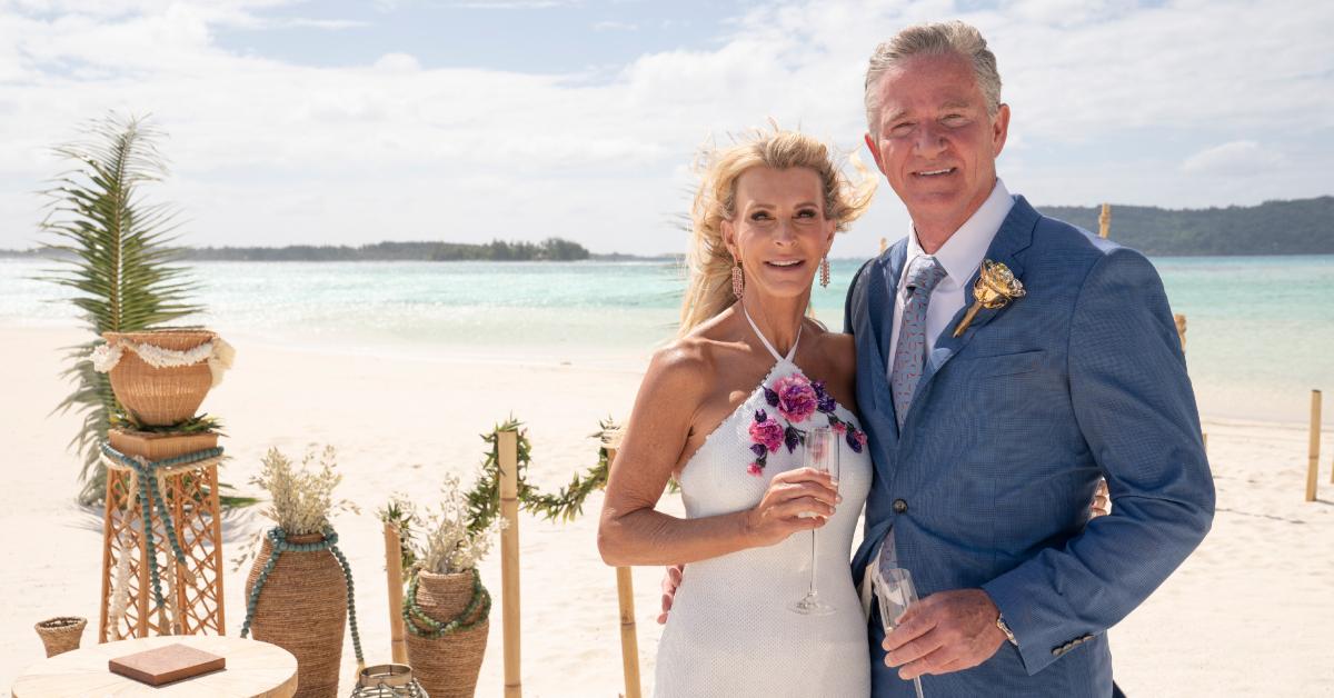 Joan and Chock pose on the beach together after getting engaged on 'The Golden Bachelorette.'