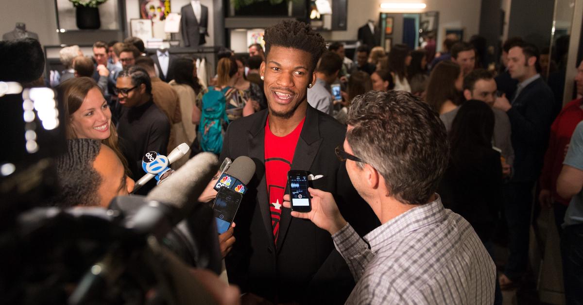 Jimmy Butler wearing a red graphic t-shirt and a black blazer to the Bonobos Michigan Avenue Launch Party on Apr. 20, 2016.