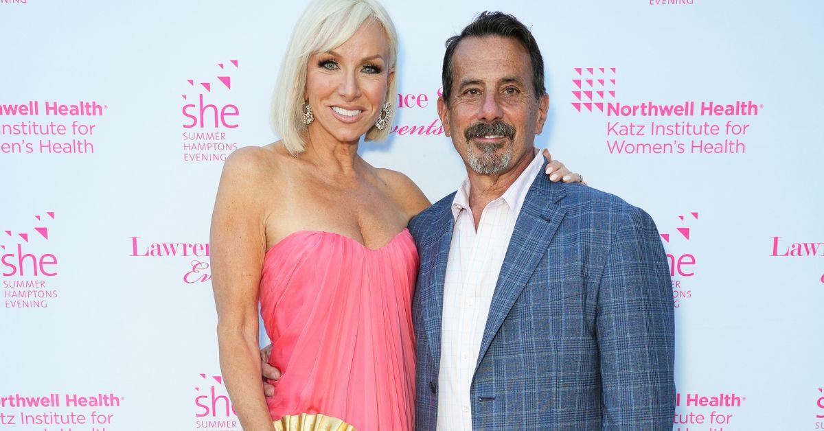 Margaret Josephs and Joe Benigno pose for a photo at an event red carpet