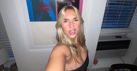 Flash selfie of TikTok creator Megan Boni standing in front of a white door