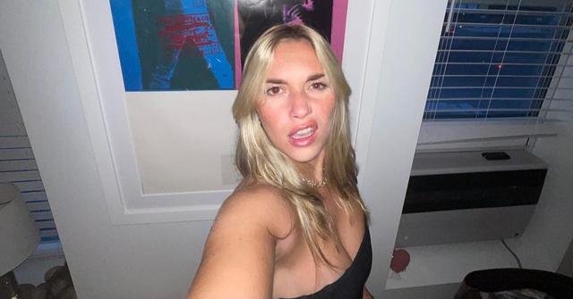 Flash selfie of TikTok creator Megan Boni standing in front of a white door