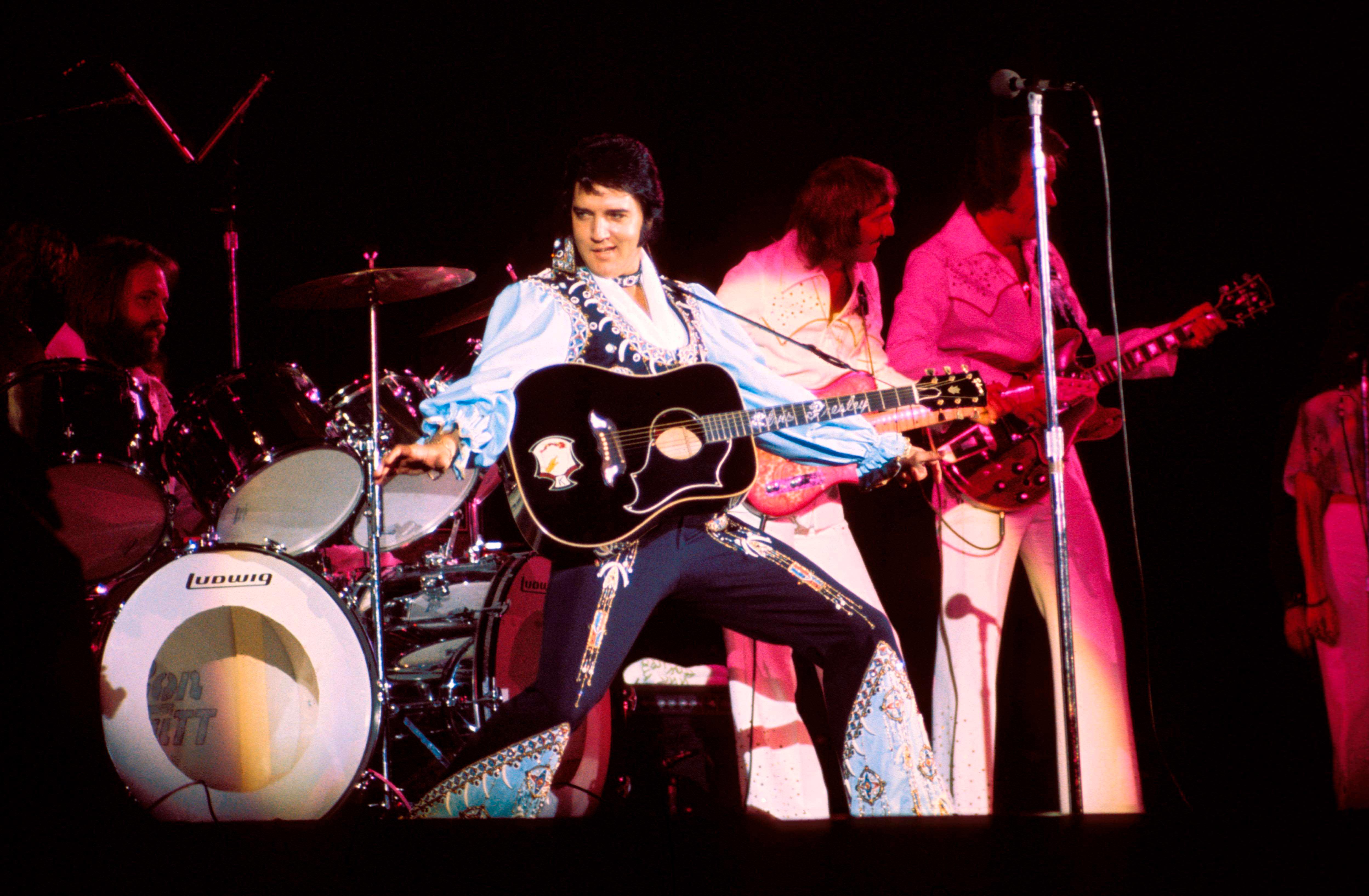 Elvis Presley performing onstage.