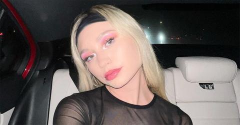 Taylor Hudson in a dress and headband in a car.