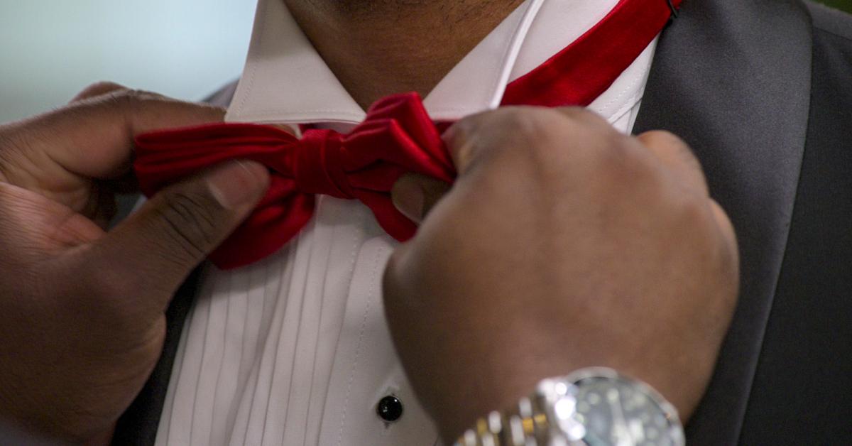 A man adjusts another man's red bowtie during during Season 8 of 'Love Is Blind.'