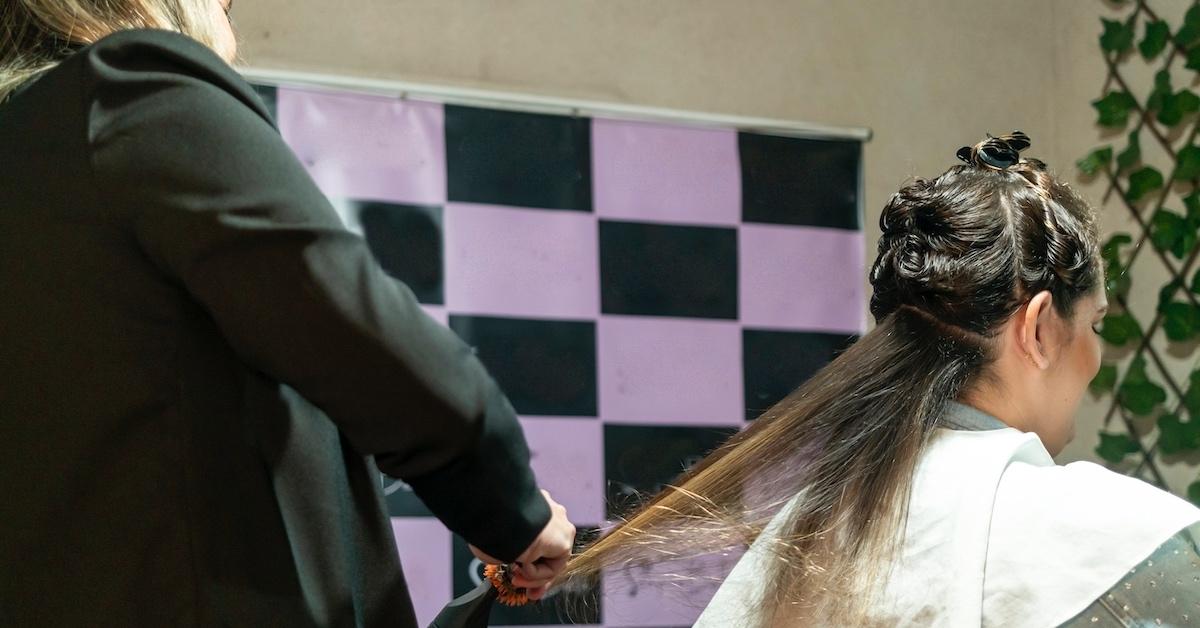 A hairstylist working on a client's hair