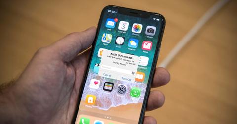 An iPhone home screen displays a screen asking for the Apple ID password.