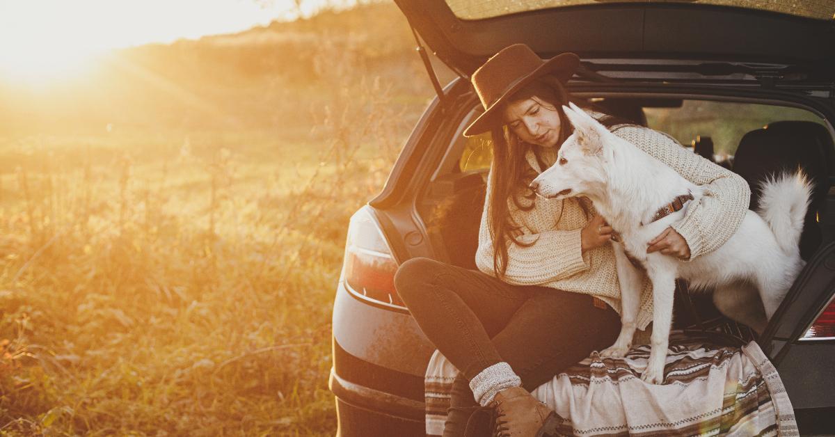 A woman and her dog during autumn.