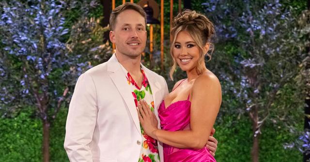 Jeramey and Sarah Ann smile and pose for the camera at the 'Love Is Blind' Season 6 reunion.