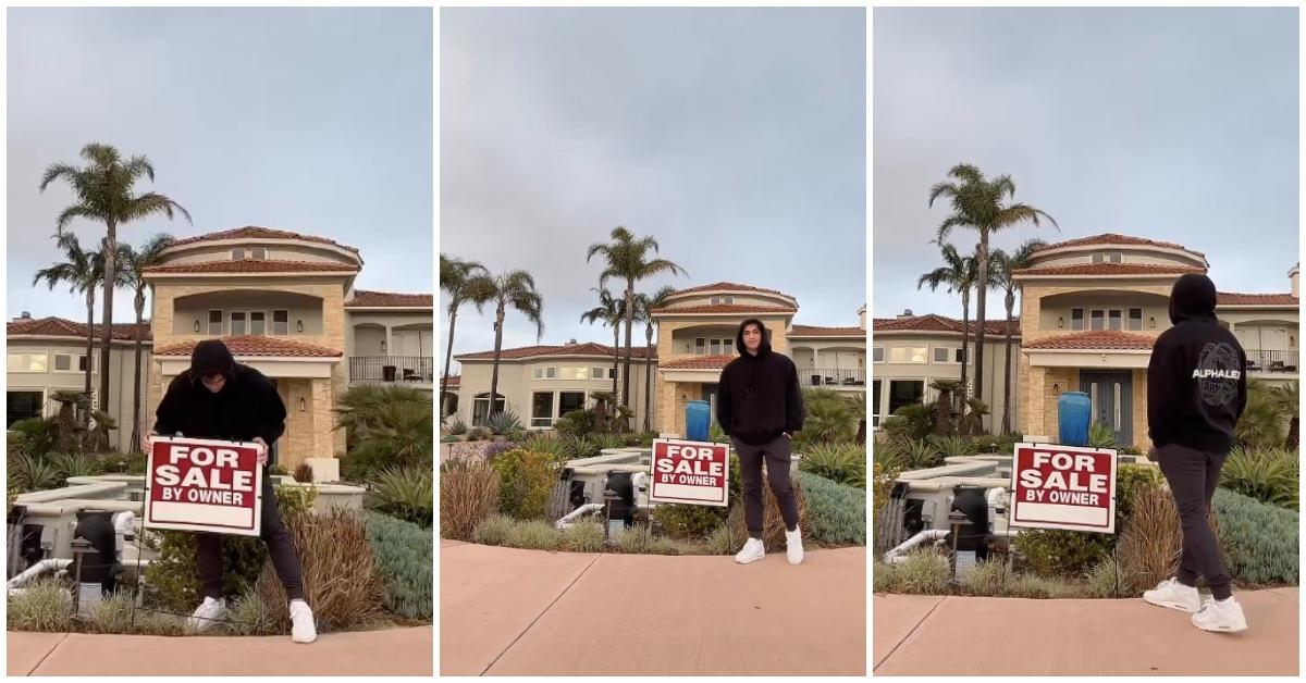 Thomas Petrou puts up a for sale sign in front of the Hype House.